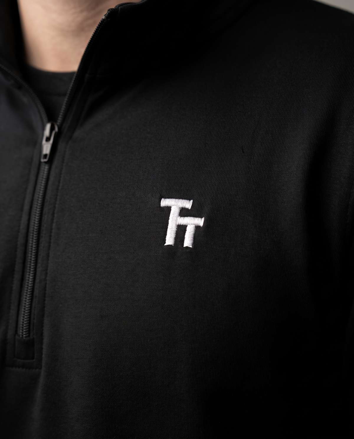 The Commit Quarter-Zip by TechThreads, embroidery close-up